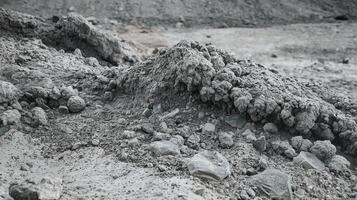 Grey Rough Rocky Terrain with Textured Surface in a Dry Desert Environment Representing Natural Erosion photo