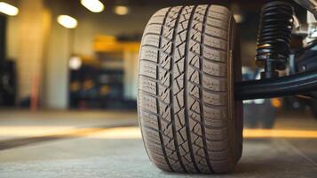 Closeup of Car Tire with Detailed Tread Pattern in a Bright Automotive Workshop Setting photo