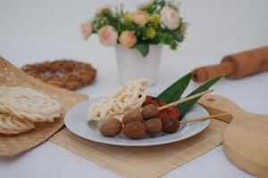 rice with skewered quail eggs and crackers on bamboo mat. Selective focus. photo