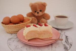 Strawberry cheese cake on a plate with eggs in basket on a table. photo