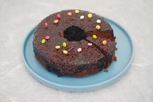 Chocolate cake on plate with marble background photo