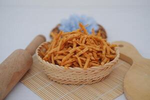 potato sticks in a basket on bamboo mat photo