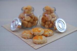 Peanut cookies and cream puffs in a jar, neatly arranged photo