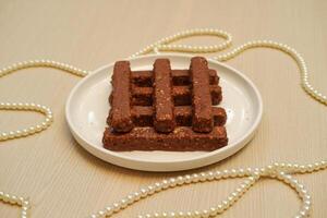 chocolate wafers on a white plate neatly arranged photo
