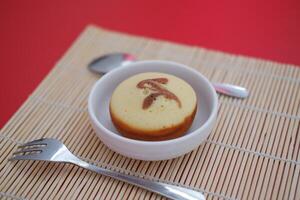 Sweet small cake served with a spoon and fork. photo