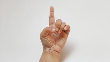 A woman hand forefinger something up isolated on white background photo