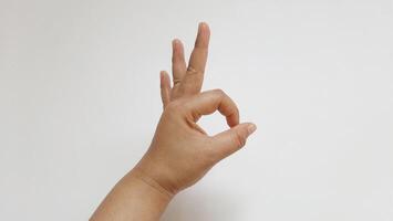 OK hand gesture isolated on white background photo