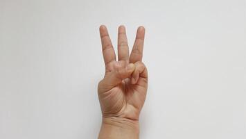 A woman hand showing three number isolated on white background photo