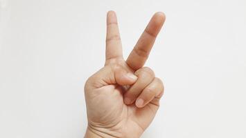 Human hand showing finger number two. Isolated on white background photo