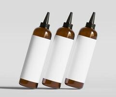 Three brown bottles with white labels on a gray background photo
