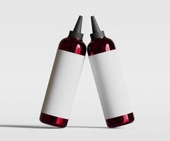 Two red bottles with white labels on a white background photo