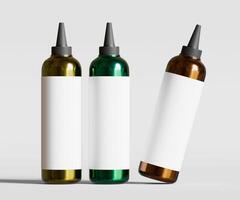 Three different colored bottles with white lids photo