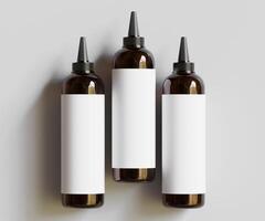 Three empty bottles with white labels on a gray background photo