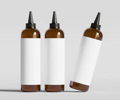 Three empty bottles with black caps on a gray background photo