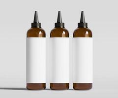 Three brown bottles with black caps on a white background photo