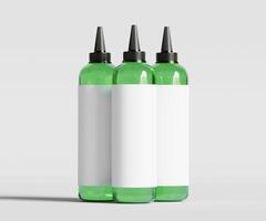 Three green bottles with black caps on a white background photo