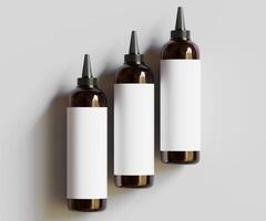 Three empty bottles with black caps on a white background photo