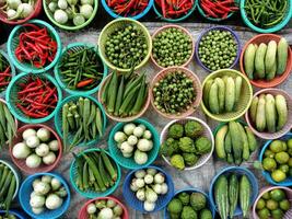 Many different types of vegetables are displayed in baskets photo