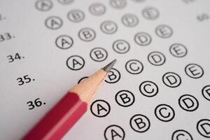 Answer sheets with pencil drawing fill to select choice, education concept. photo