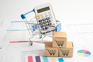 Online shopping, Shopping cart box on business graph, import export, finance commerce. photo