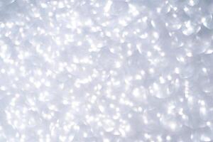 Abstract white light bokeh background with soft circular patterns and bright glowing effects. photo