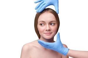 Young caucasian female preparing for cosmetic procedure with blue gloves in medical setting. photo