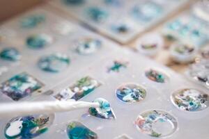 Crafting resin molds with colorful designs in progress. photo