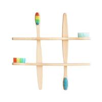Bamboo toothbrushes with colorful bristles arranged in tic tac toe pattern. photo