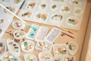 Molded resin art with colorful shells and botanical elements in various silicone molds. photo