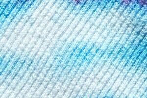 Close up texture of blue and white knitted fabric with gradient patterns. photo
