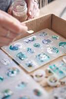 Diy crafting with epoxy resin. creating personalized jewelry with artistic molds and inclusions. photo