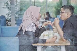 romantic married Asian Muslim couple looking at each other photo