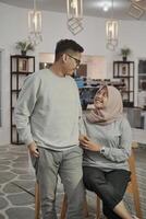 lovely asian Muslim young couple embracing at indoors photo