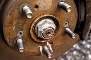 Close up of lock nut of front axle shaft in the vehicle engine powertrain system , Automotive parts concept photo