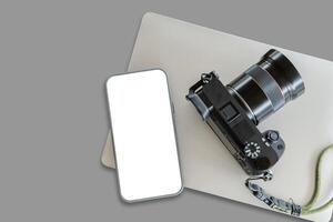 Top view of smartphone mock up screen on the white table with copy space. Camera on white table background. photo