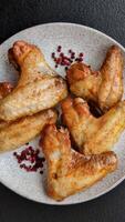 Grilled chicken wings with salt and spices on concrete background video