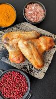 Grilled chicken wings with salt and spices on background video