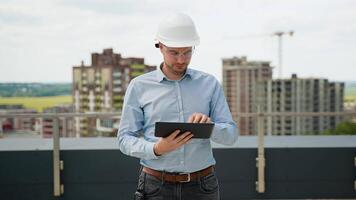 Construction engineer using tablet for project supervision on rooftop site video