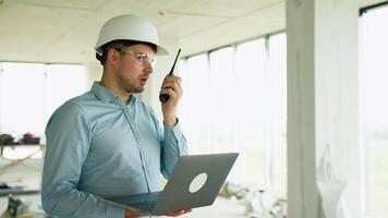 Civil engineer communicating with team via radio video