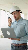Construction Engineer Using Laptop and Radio on Job Site video