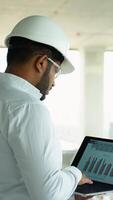 Indian Builder Engineer Using Laptop for Data Analysis at Worksite video