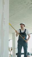 Builder Applying Wall Coating with Roller at Construction Site video
