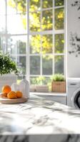 Bright and airy kitchen with fresh oranges on a marble countertop photo