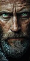 A rugged man stares intently, showcasing weathered skin and a bushy beard photo