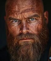 Rugged man with strong features and a thick beard gazes intensely photo