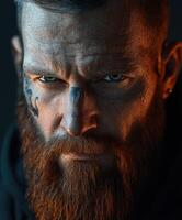 Intense portrait of a man with a beard and tattoos in dramatic lighting photo