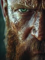 Bearded man with piercing green eyes and intense expression in close-up photo