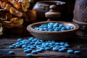 Colorful blue tablets scattered on a wooden surface with rustic decor photo