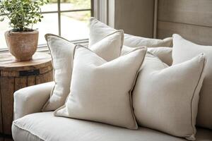 Decorative pillows arranged on a cozy couch in a bright living room photo