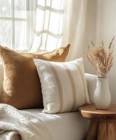 Cozy living room corner with pillows and dried flowers in a vase photo